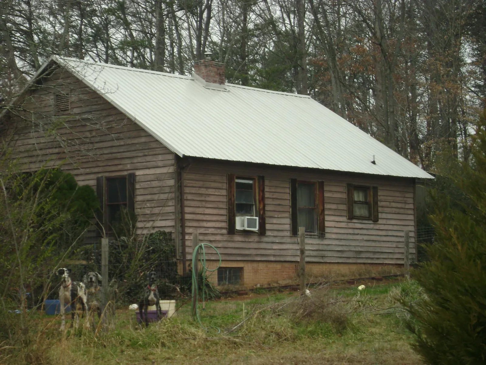 White metal roof on an old wood sided farmhouse, from a Metal Roof Installation job in Valley Spring